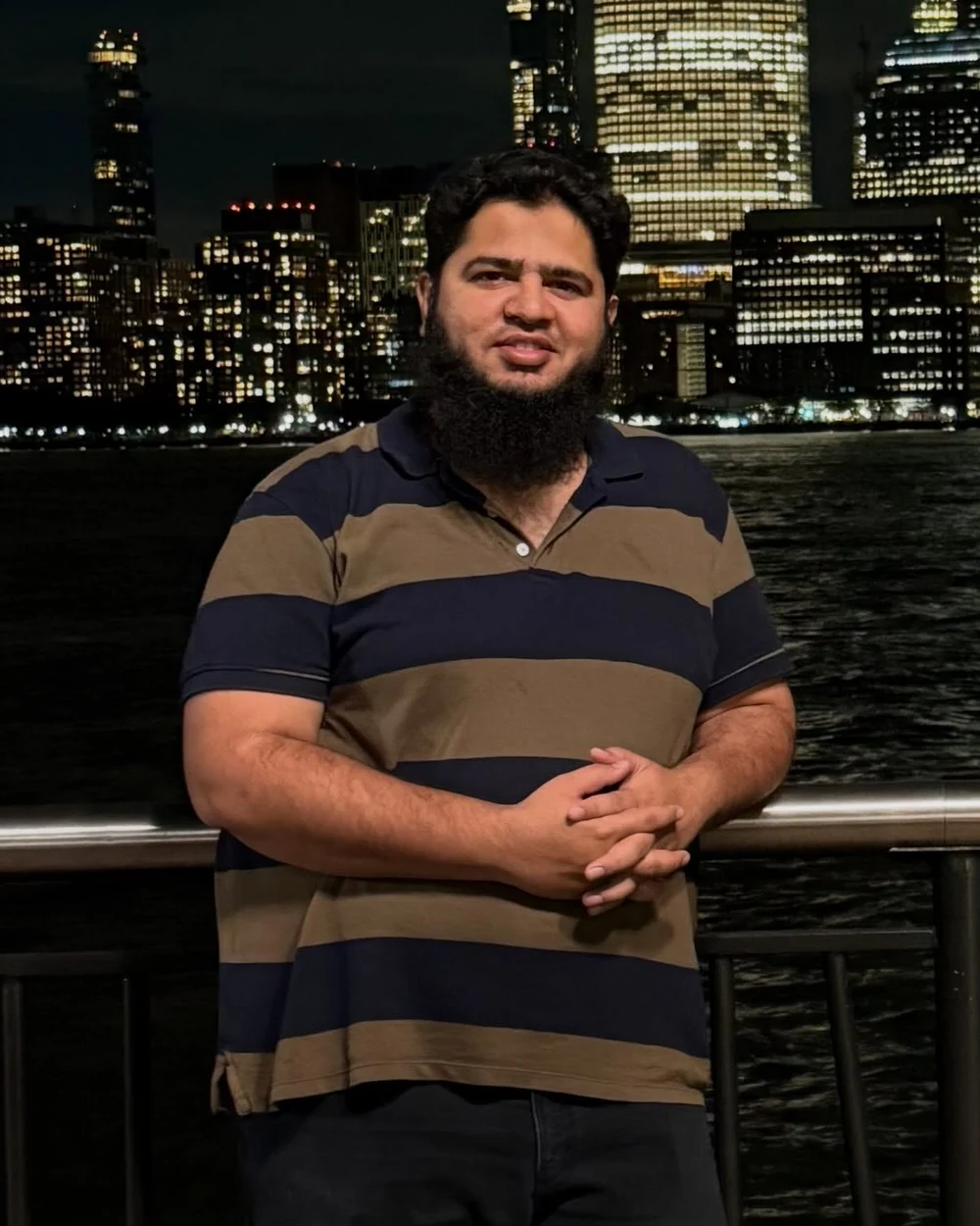 Shaikh Simraan, founder of Go Easy Media, photographed against the Manhattan skyline at night